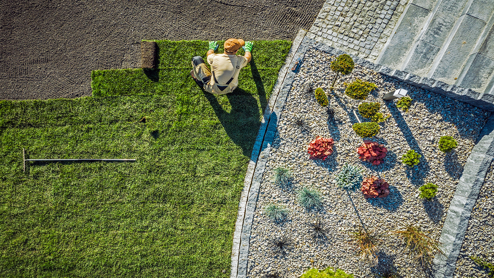 Roseville Landscaping Pros Aerial View of Sod Squares Being Laid Next to Rock Bed SOD Installation 1